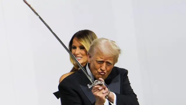 Donald Trump hols sword to cut cake at inauguration ball