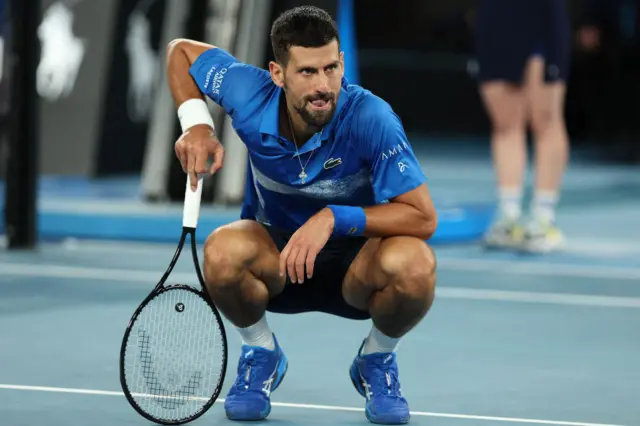 Novak Djokovic drops to his haunches