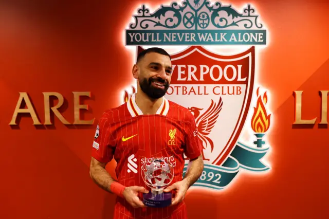 Mohamed Salah with the UEFA Champions League Man of the Match trophy.