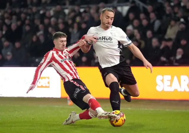 Sunderland's Trai Hume (left) and Derby County's Kane Wilson battle for the ball