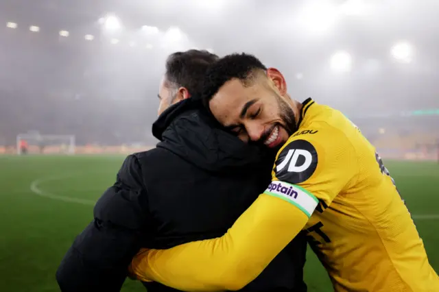 Matheus Cunha hugging manager Vitor Pereira