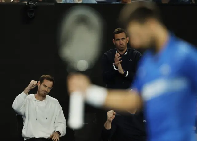 Andy Murray celebrates with Novak Djokovic in the foreground