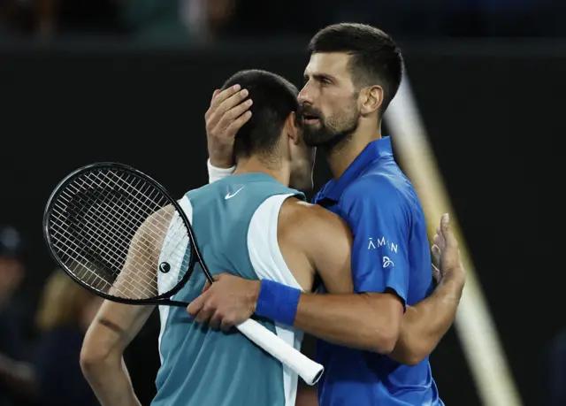 Novak Djokovic hugs Carlos Alcaraz