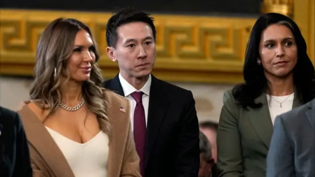 TikTok CEO Shou Chew (C) stands with US Director of National Intelligence nominee Tulsi Gabbard (R), during the 60th Presidential Inauguration in the Rotunda of the US Capitol in Washington.