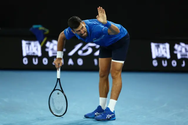 Novak Djokovic bends over