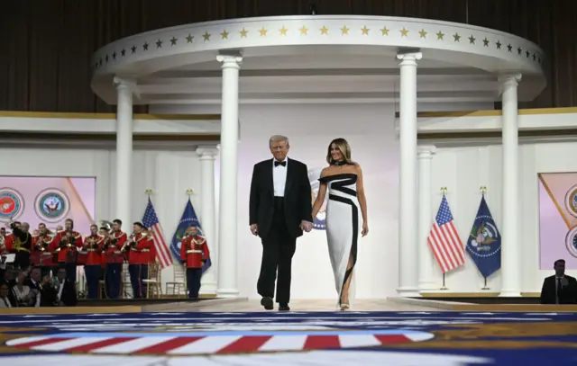 Donald and Melania Trump walk down stage