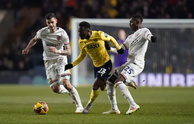 Oxford United's Siriki Dembele and Luton Town's Joe Taylor (right) battle for the ball