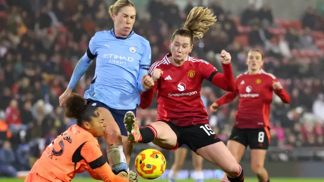 Manchester City's Khiara Keating and Rebecca Knaak in action with Manchester United's Elisabeth Terland