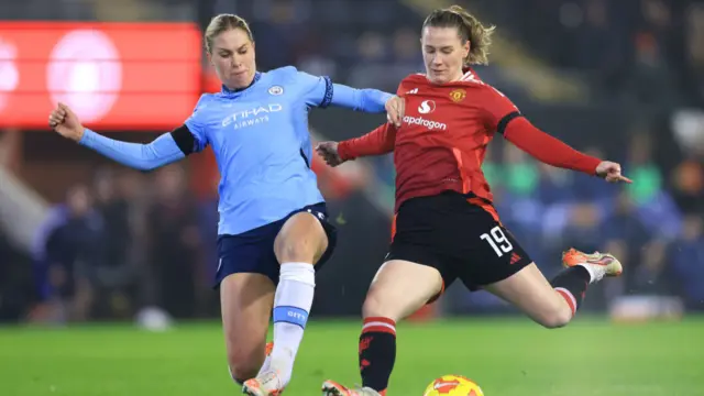 Rebecca Knaak of Manchester City tackles Elisabeth Terland of Manchester United during the Subway Women's League Cup match between Manchester United and Manchester City