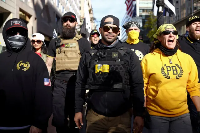 A line of Proud Boys marching