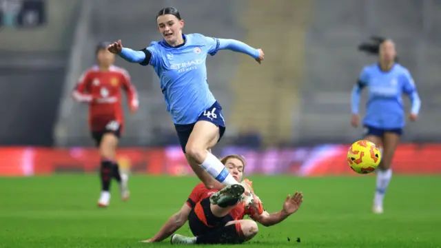 Lily Murphy of Manchester City is tackled by Aoife Mannion of Manchester United during the Subway Women's League Cup match between Manchester United and Manchester City