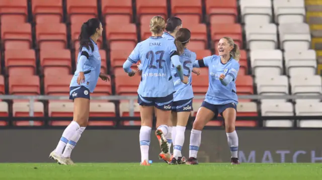 Lily Murphy of Manchester City celebrates scoring her team's second goal with team mates during the Subway Women's League Cup match between Manchester United and Manchester City