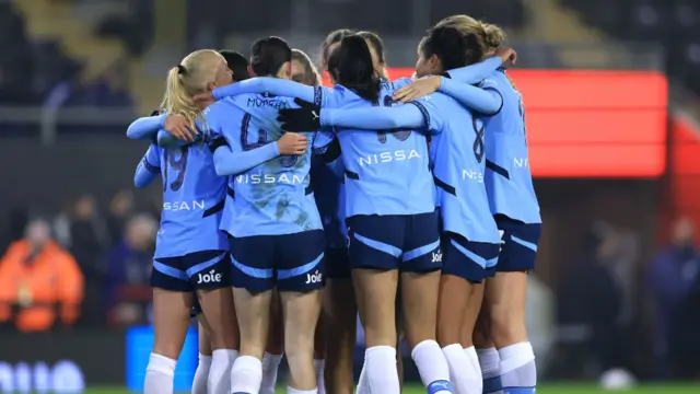 Laura Coombs of Manchester City (unseen) celebrates scoring her team's first goal with team mates during the Subway Women's League Cup match between Manchester United and Manchester City