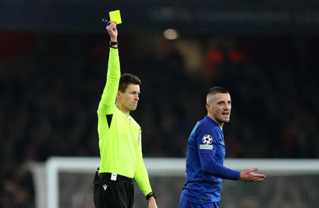 GNK Dinamo Zagreb's Arijan Ademi is shown a yellow card by referee Daniel Siebert