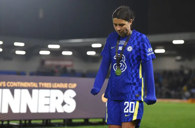 Sam Kerr trudges off the pitch wearing her runners up medal