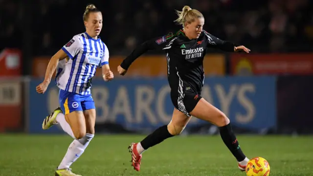 Alessia Russo of Arsenal runs with the ball whilst under pressure from Rachel McLauchlan of Brighton & Hove Albion