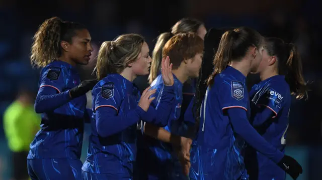 Erin Cuthbert of Chelsea celebrates with teammates after scoring her team's third goal during the Subway Women's League Cup match between Chelsea and Durham at Kingsmeadow