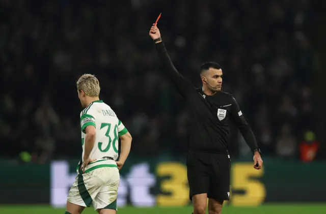 Celtic's Daizen Maeda is shown a red card by referee Rohit Saggi