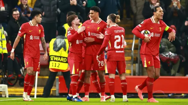 Liverpool players celebrate after taking the lead against Lille