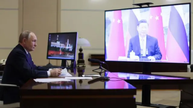 Russian President Vladimir Putin holds a meeting with Chinese President Xi Jinping (on screen) via video conference at the Novo-Ogaryovo state residence, outside Moscow, Russia, 21 January 2025.