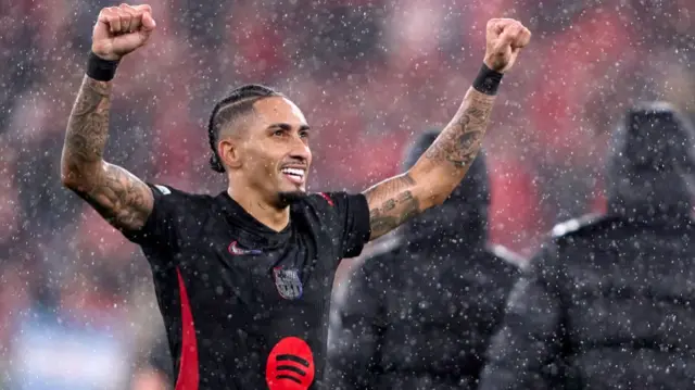 Barcelona forward Raphinha celebrates after scoring against Benfica