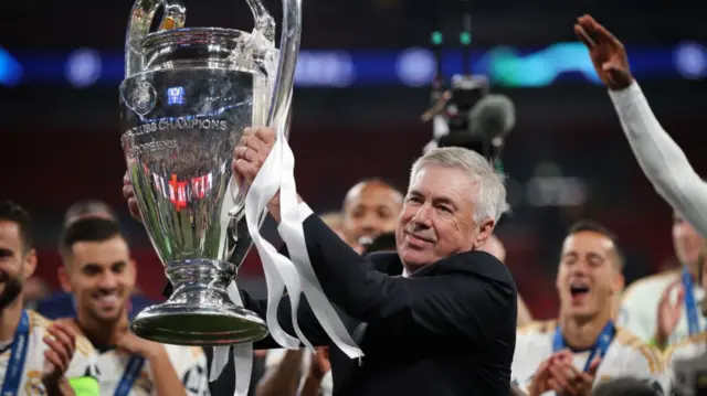 Real Madrid head coach Carlo Ancelotti lifts the Champions League trophy