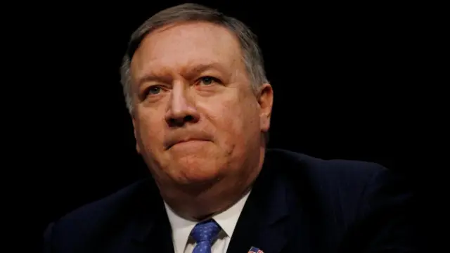 A close up of Mike Pompeo, who wears a suit and looks past the camera