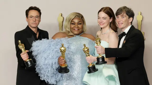 Robert Downey Jr, Da'Vine Joy Randolph, Emma Stone and Cillian Murphy hold up their golden Oscars on the red carpet