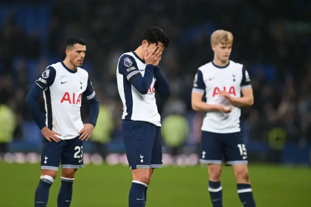 Son covers his face with his hands as Bergvall and Porro stand close by