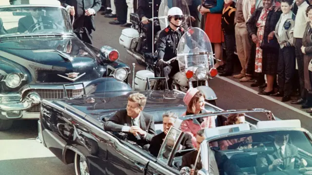 US President John F Kennedy, First Lady Jacqueline Kennedy, Texas Governor John Connally, and others smile at the crowds lining their motorcade route in Dallas, Texas, on November 22, 1963. Minutes later the President was assassinated as his car passed through Dealey Plaza.