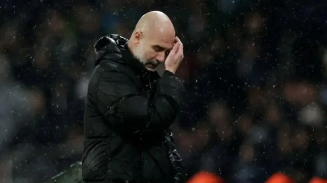 Pep Guardiola scratching his head