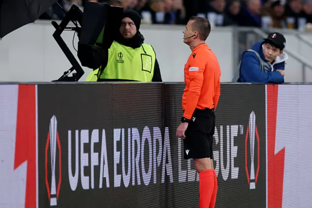 Referee Morten Krogh checks the pitch side VAR