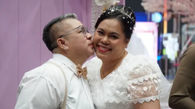 A smiling couple in white