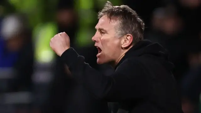 Phil Parkinson shouts with a clenched fist