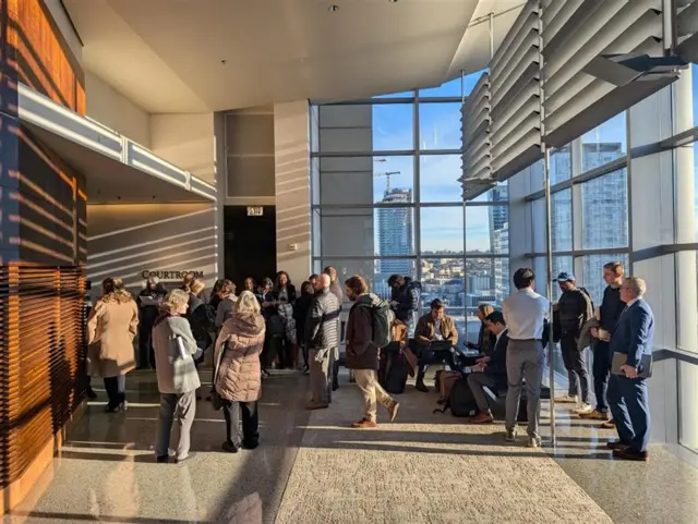 People stand outside a Seattle courtroom