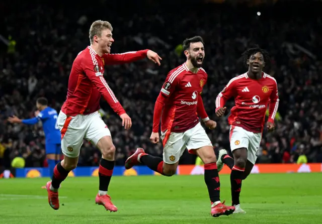 Bruno Fernandes of Manchester United (centre) celebrates scoring his team's second goal during the UEFA Europa League 2024/25 League Phase MD7 match between Manchester United and Rangers FC at Old Trafford