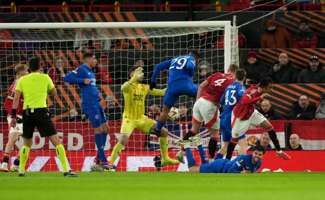 Manchester United's Matthijs de Ligt (4) scores a goal that is later ruled out after a shove from team-mate Leny Yoro (right) on Rangers' Robin Propper (on ground) during the UEFA Europa League, league stage match at Old Trafford, Manchester