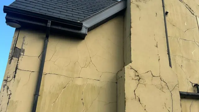 A house with several large cracks in it