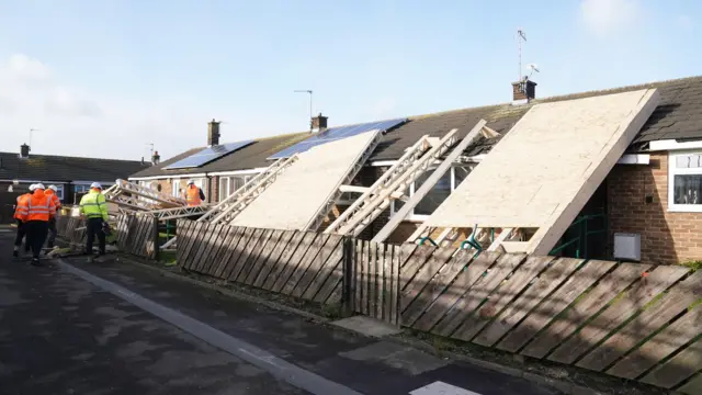 blown off during strong winds rests on some bungalows in Amble, Northumberland