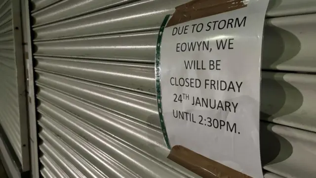 A sign taped to a shop shutter in Co Down saying it is closed on Friday morning because of the storm