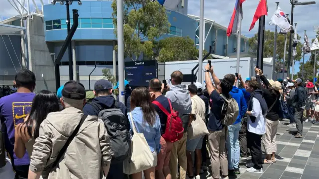 Fans watch Novak Djokovic practice