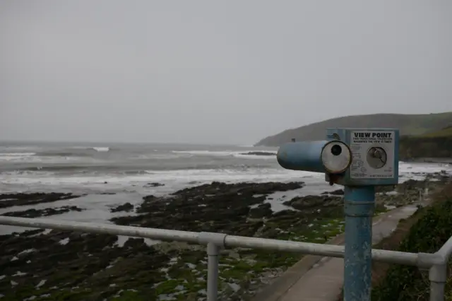 A picture of grey skies over Looe. The seafront can be seen.