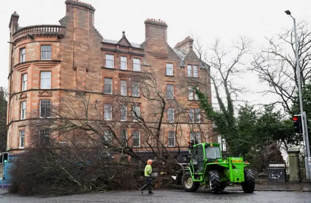 Council workers remove a fallen tree that blocks the Regent Road, as Storm Eowyn hits, in Edinburgh, Scotland, Britain, January 24, 2025. REUTERS/Lesley Martin