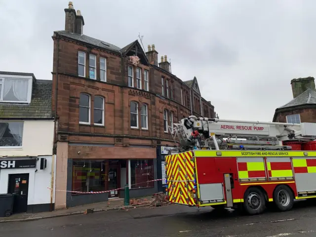 A fire engine outside a sandstone building in Dumfries after part of a building collapsed