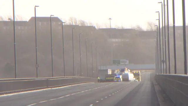 Police vehicles at the empty three-lane bridge