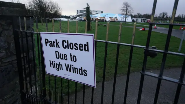 A sign says the park is closed due to high winds