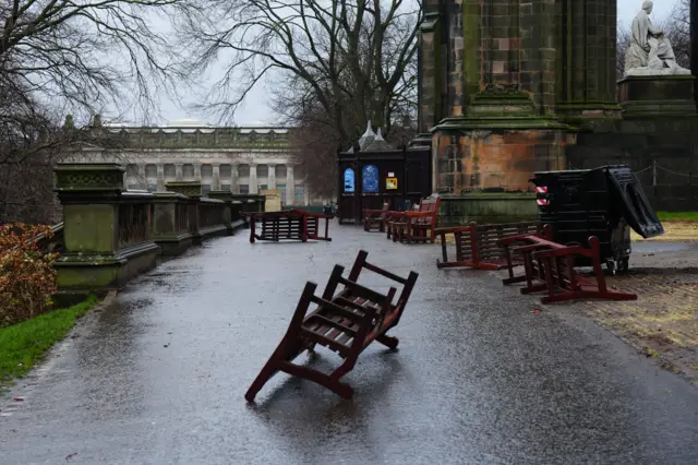 Benches strewn across Princes Street Gardens in Edinburgh during Storm Eowyn