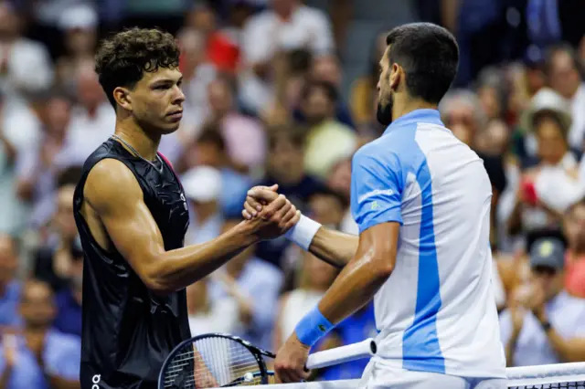 Novak Djokovic of Serbia shakes hands with Ben Shelton of the United States