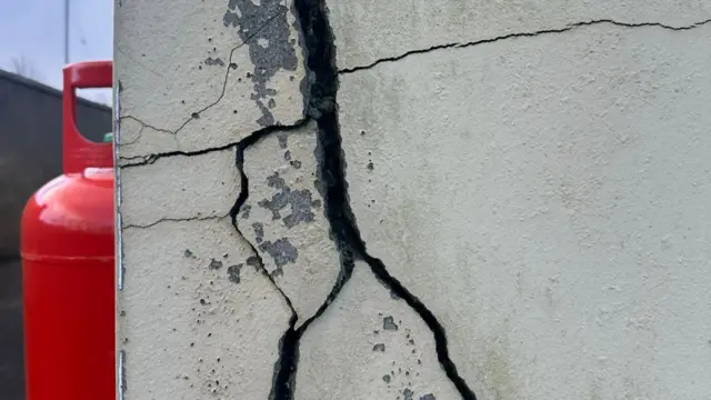 A large crack on the side of their house