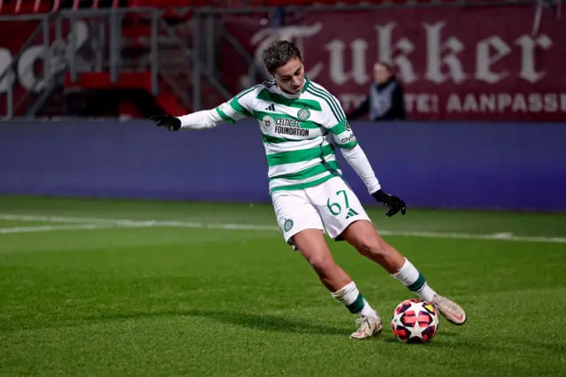 A female football player running and kicking the ball